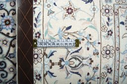 Backside of handmade New Nain rug showing knot structure and weave density