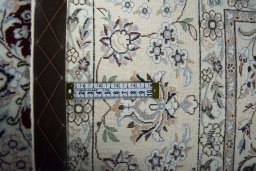 Backside of handmade New Nain rug showing knot structure and weave density