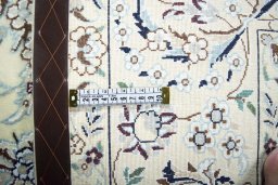 Backside of handmade New Nain rug showing knot structure and weave density