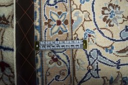 Backside of handmade New Nain rug showing knot structure and weave density