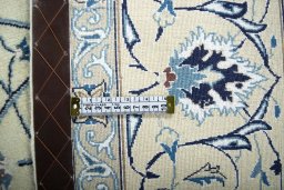 Backside of handmade New Nain rug showing knot structure and weave density