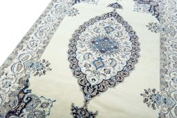 Backside of handmade New Nain rug showing knot structure and weave density