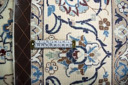 Backside of handmade New Nain rug showing knot structure and weave density