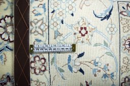 Backside of handmade New Nain rug showing knot structure and weave density