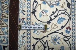 Backside of handmade New Nain rug showing knot structure and weave density
