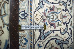 Backside of handmade New Nain rug showing knot structure and weave density