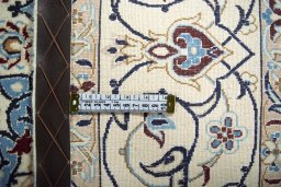 Backside of handmade New Nain rug showing knot structure and weave density