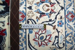 Backside of handmade New Nain rug showing knot structure and weave density