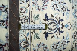 Backside of handmade New Nain rug showing knot structure and weave density