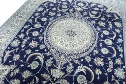 Backside of handmade New Nain rug showing knot structure and weave density