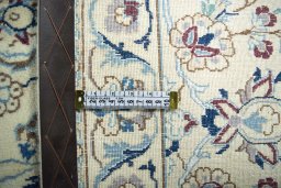 Backside of handmade New Nain rug showing knot structure and weave density