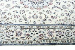 Corner detail of 2000s Nain rug showing border pattern and Wool pile