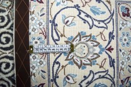 Backside of handmade New Nain rug showing knot structure and weave density