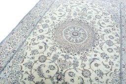 Backside of handmade New Nain rug showing knot structure and weave density