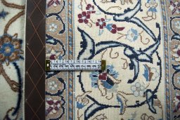 Backside of handmade 2000s Nain rug showing knot structure and weave density