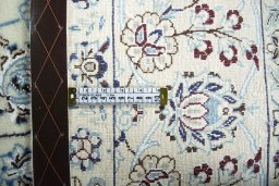 Backside of handmade New Nain rug showing knot structure and weave density