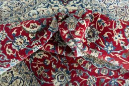 Surface texture of 2000s Nain rug with natural Wool and intricate pattern