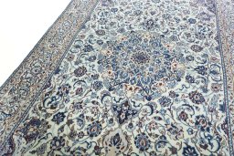 Backside of handmade 2000s Nain rug showing knot structure and weave density