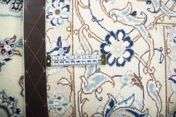 Backside of handmade New Nain rug showing knot structure and weave density