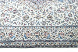 Corner detail of 2000s Nain rug showing border pattern and Wool pile