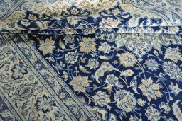 Surface texture of 2000s Nain rug with natural Wool and intricate pattern