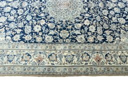 Corner detail of 1970s Nain rug showing border pattern and Cork pile