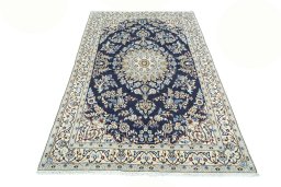Surface texture of 2000s Nain rug with natural Wool and intricate pattern