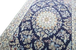 Backside of handmade 2000s Nain rug showing knot structure and weave density