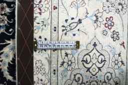 Backside of handmade New Nain rug showing knot structure and weave density