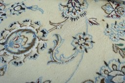 Backside of handmade New Nain rug showing knot structure and weave density