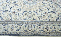Corner detail of 2000s Nain rug showing border pattern and Wool pile