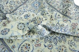 Surface texture of 2000s Nain rug with natural Wool and intricate pattern