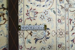 Backside of handmade New Nain rug showing knot structure and weave density