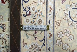 Backside of handmade New Nain rug showing knot structure and weave density