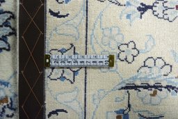 Backside of handmade New Nain rug showing knot structure and weave density