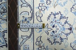 Backside of handmade New Nain rug showing knot structure and weave density