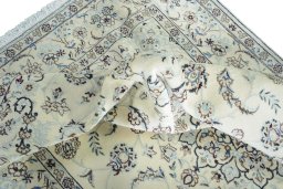 Surface texture of 2000s Nain rug with natural Wool and intricate pattern