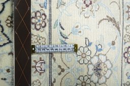 Backside of handmade 2000s Nain rug showing knot structure and weave density
