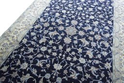Backside of handmade 2000s Nain rug showing knot structure and weave density
