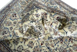 Surface texture of 2000s Nain rug with natural Wool and intricate pattern