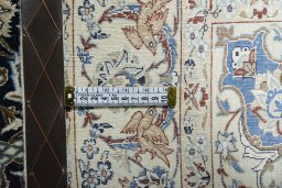 Backside of handmade 1970s Nain rug showing knot structure and weave density