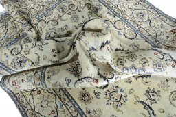 Surface texture of 2000s Nain rug with natural Wool and intricate pattern
