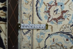 Backside of handmade New Nain rug showing knot structure and weave density