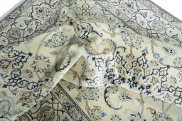 Surface texture of 2000s Nain rug with natural Wool and intricate pattern