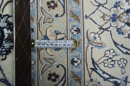 Backside of handmade New Nain rug showing knot structure and weave density