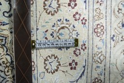 Backside of handmade New Nain rug showing knot structure and weave density