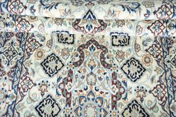 Corner detail of 2000s Nain rug showing border pattern and Wool pile