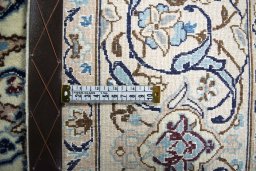 Backside of handmade New Nain rug showing knot structure and weave density