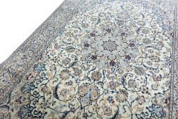 Backside of handmade New Nain rug showing knot structure and weave density
