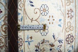 Backside of handmade New Nain rug showing knot structure and weave density
